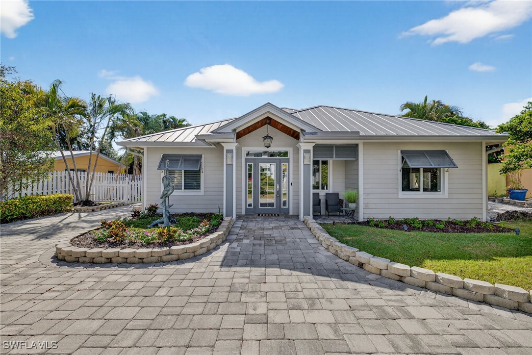 View of front of house with a metal roof