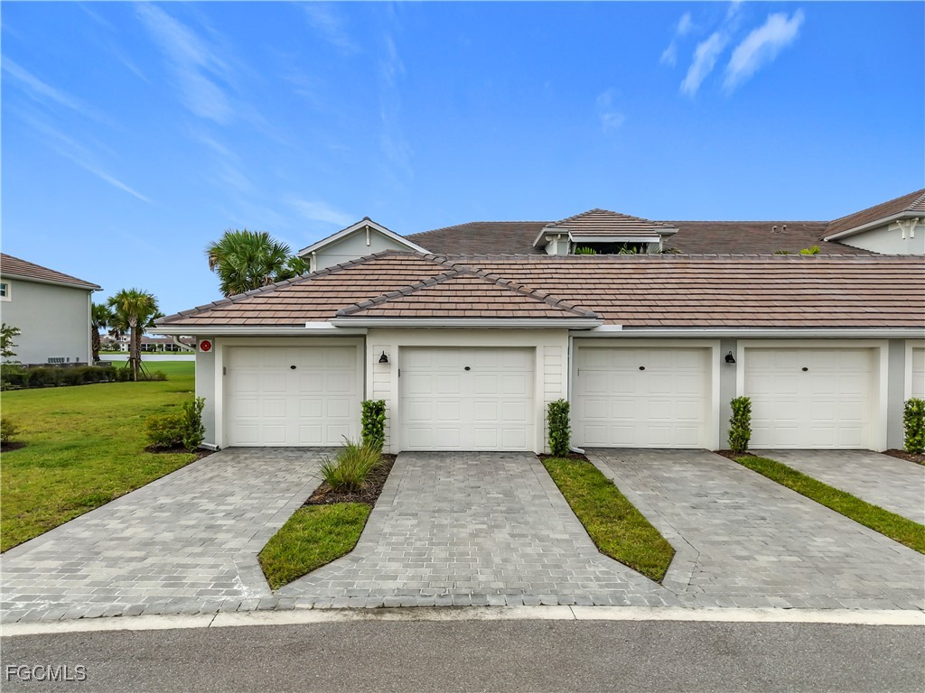 View of front of house featuring a tile roof and a