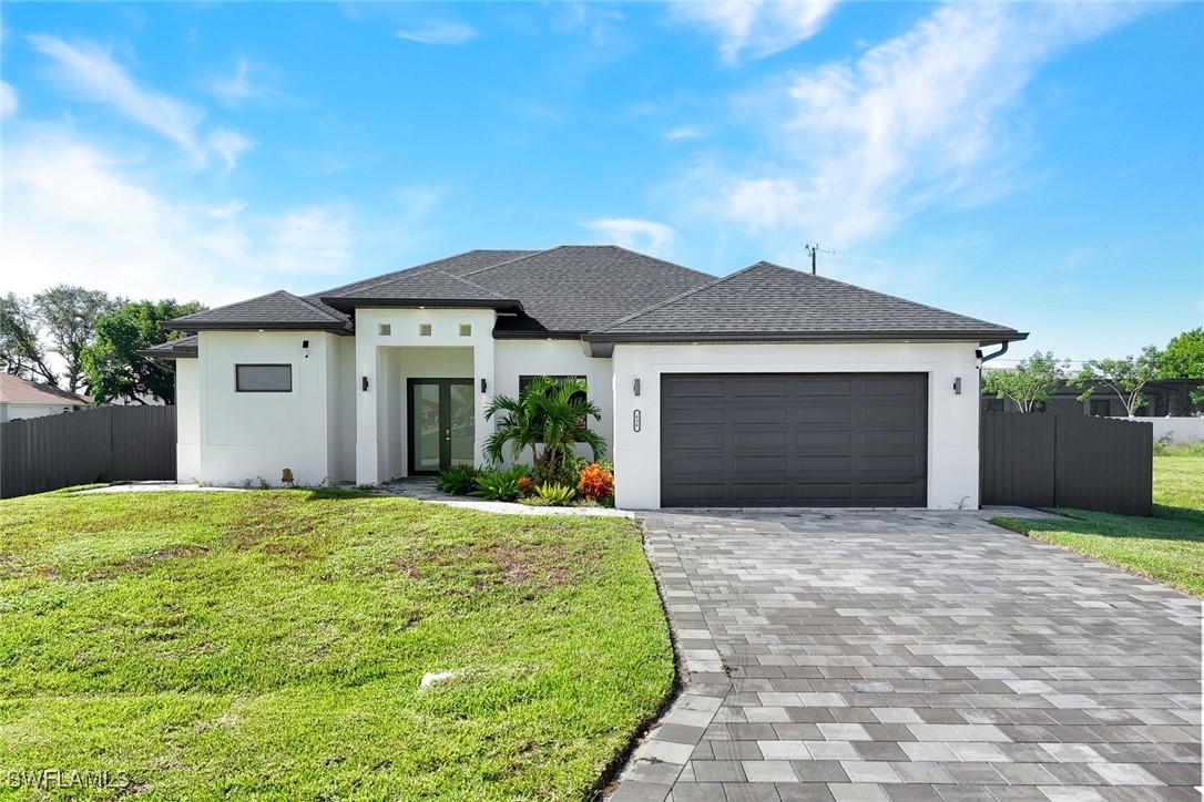 Modern house with stucco siding, decorative drivew
