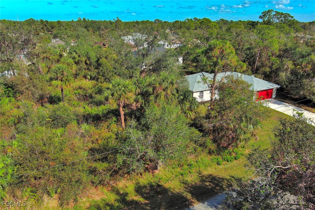 View from above of property with a heavily wooded