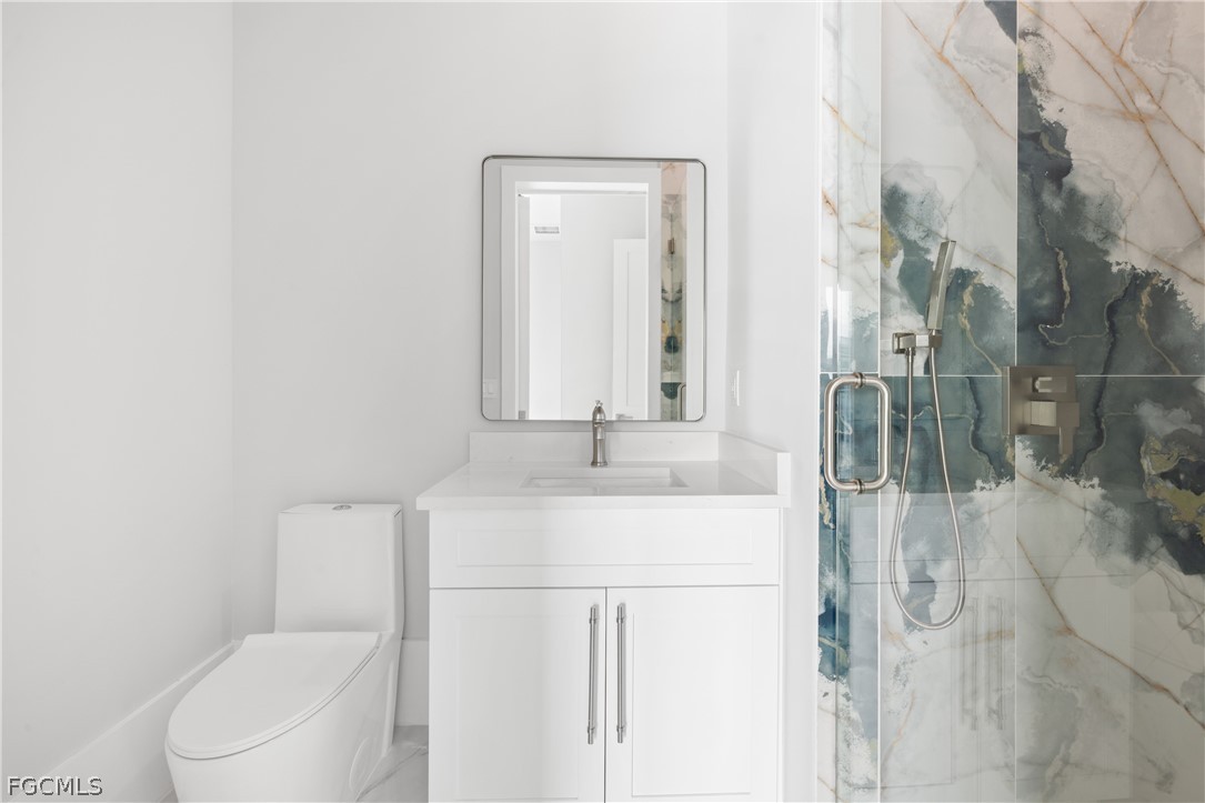 Full bathroom featuring a marble finish shower and