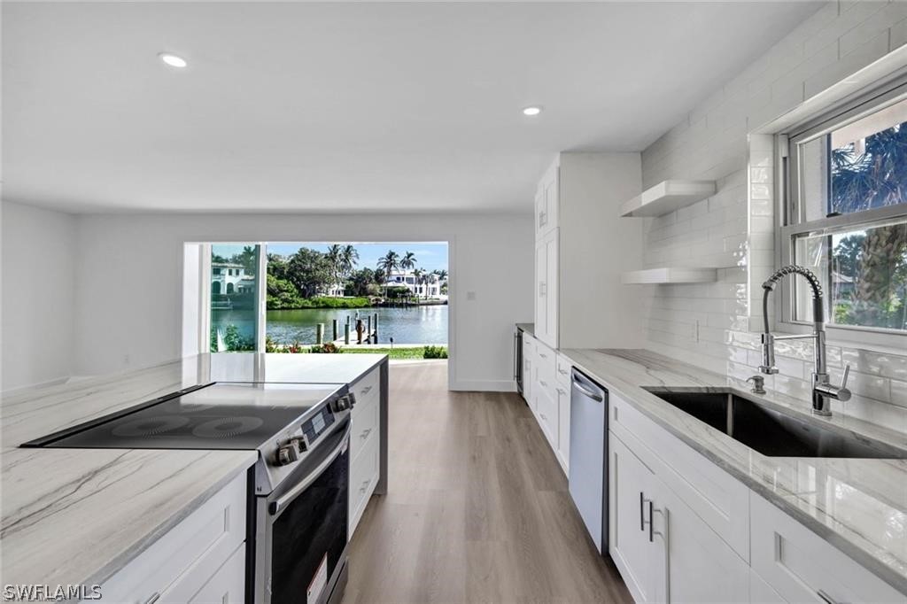 Kitchen with open shelves, stainless steel applian