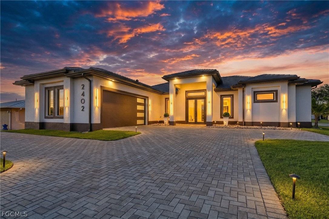 Prairie-style home with a garage, decorative drive
