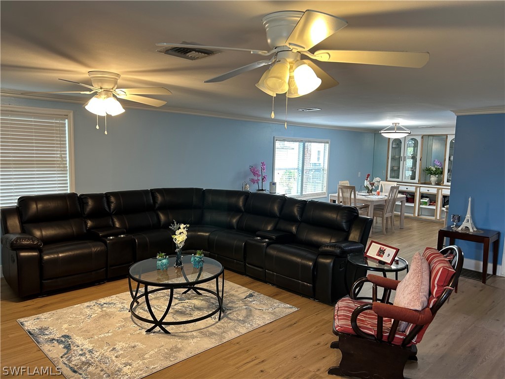 Living room with ornamental molding, vinyl finishe