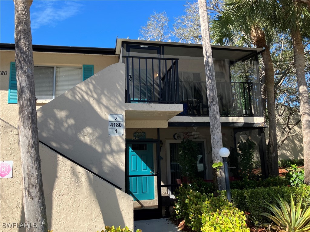 View of front of house featuring a balcony and stu