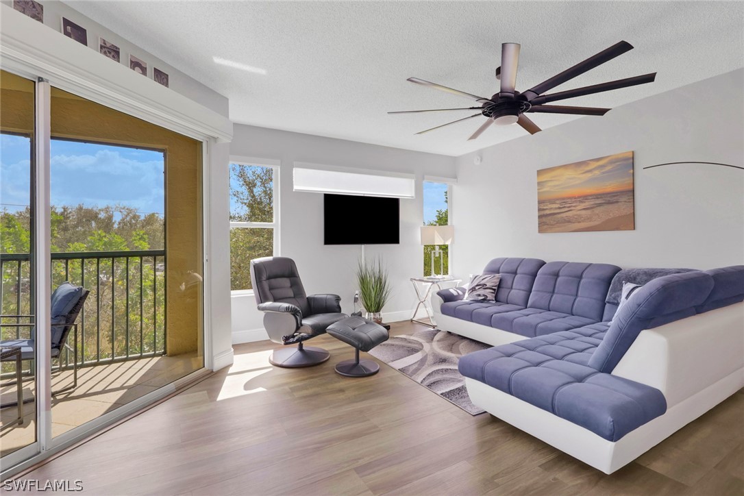 Living area featuring wood finished floors, a ceil
