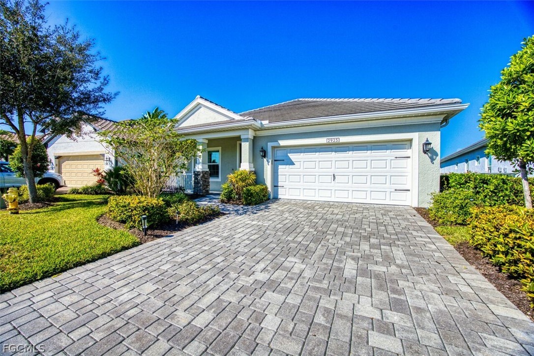 View of front facade with decorative driveway, cov