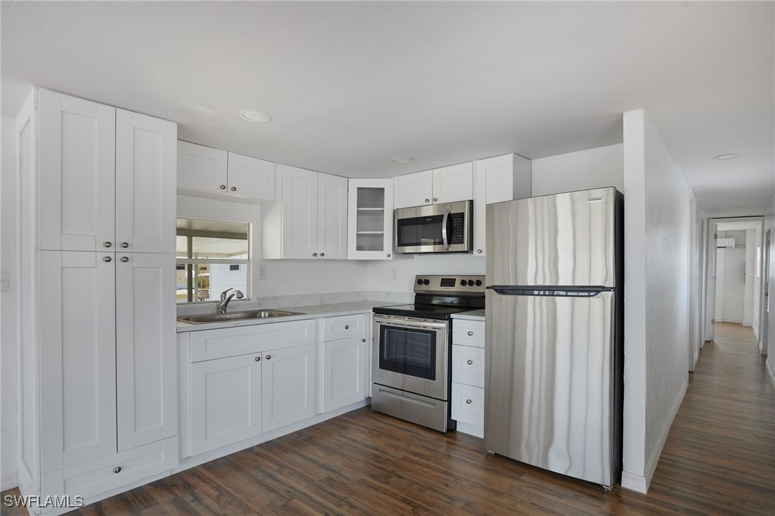 Kitchen with light countertops, stainless steel ap