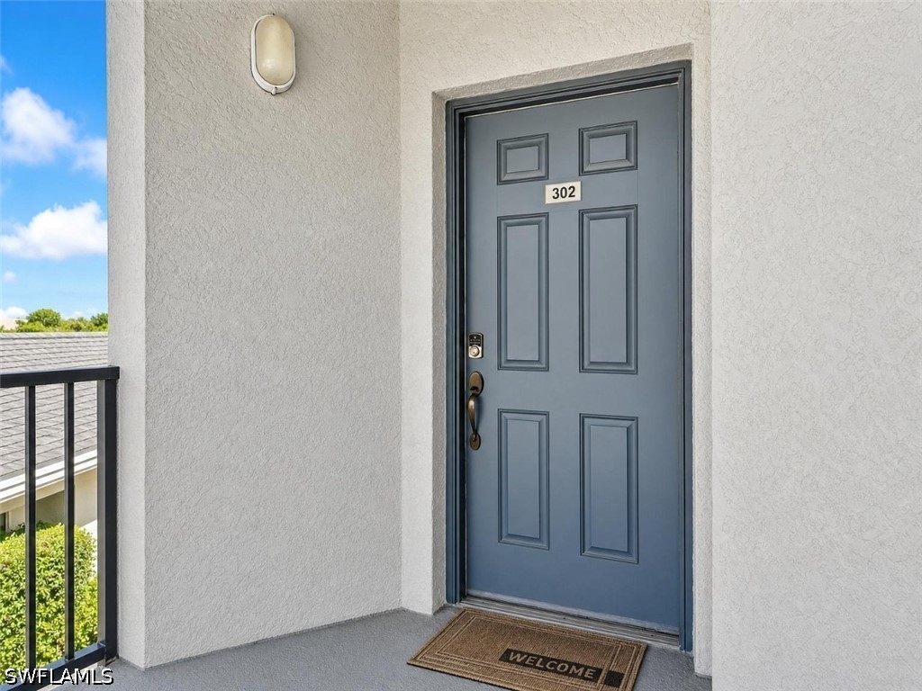 Hallway with tile patterned floors and baseboards
