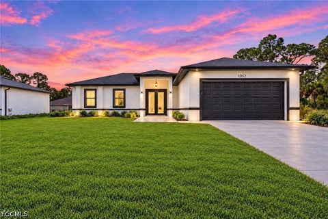 Photo of 1052 Barnett Street E, Lehigh Acres, FL 33974 (MLS # 2026041703)