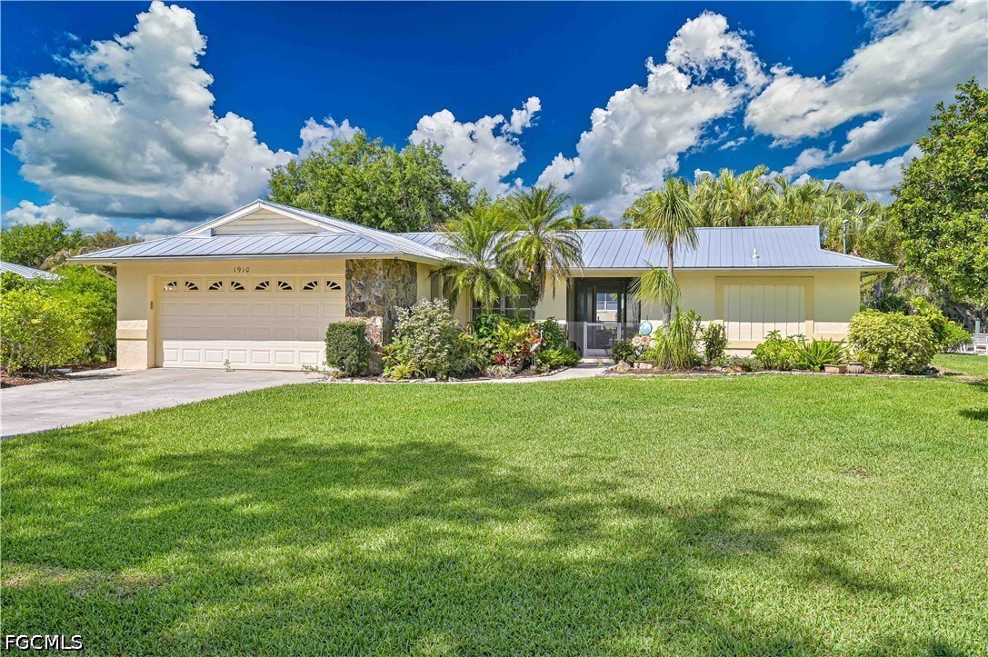 The property features a well-maintained lawn, a pa