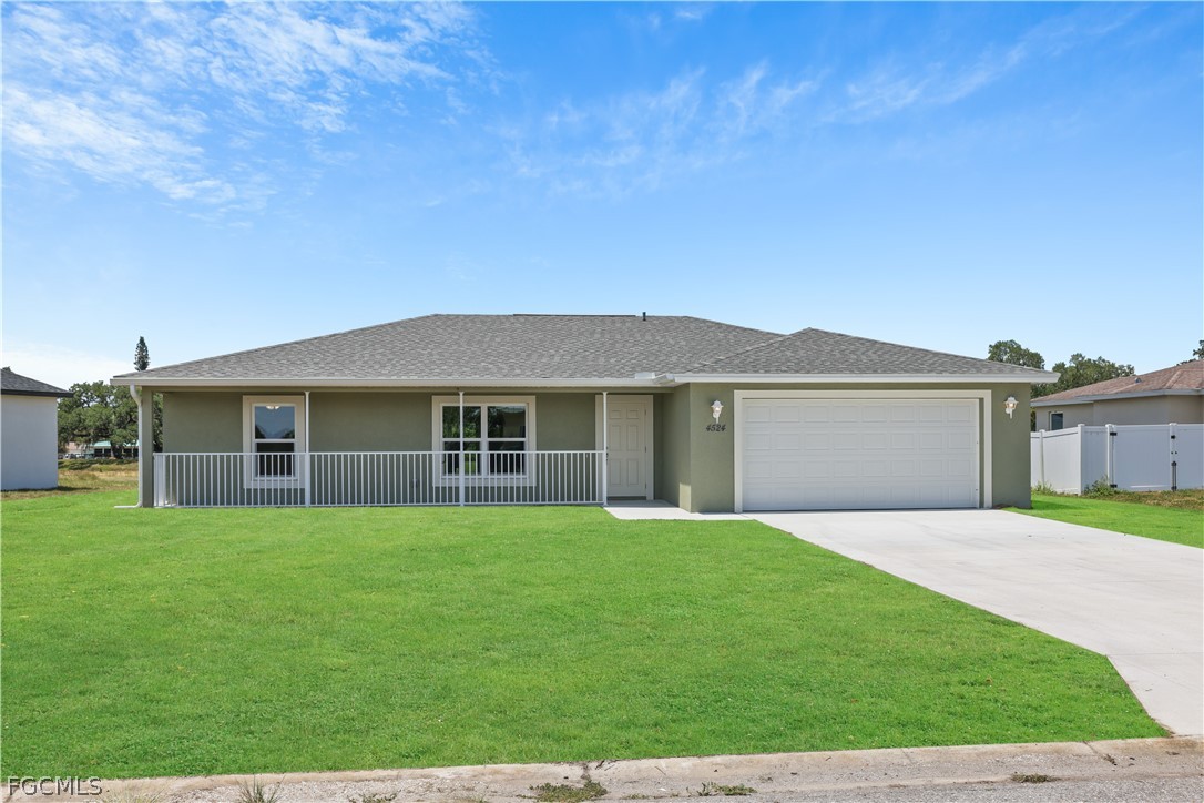Ranch-style home with stucco siding, driveway, a s