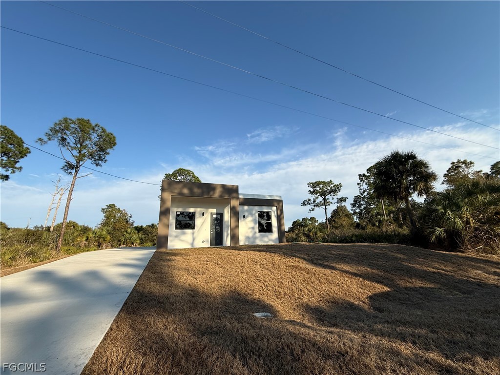 View of front of house featuring stucco siding, an