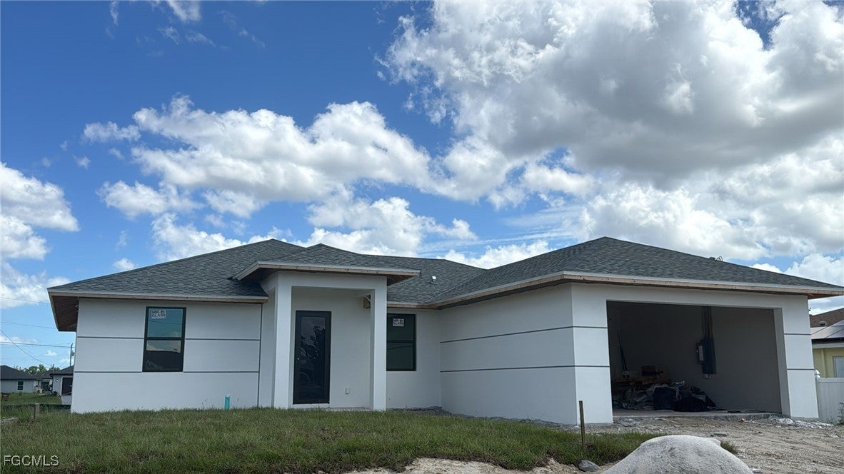 View of front facade featuring roof with shingles,