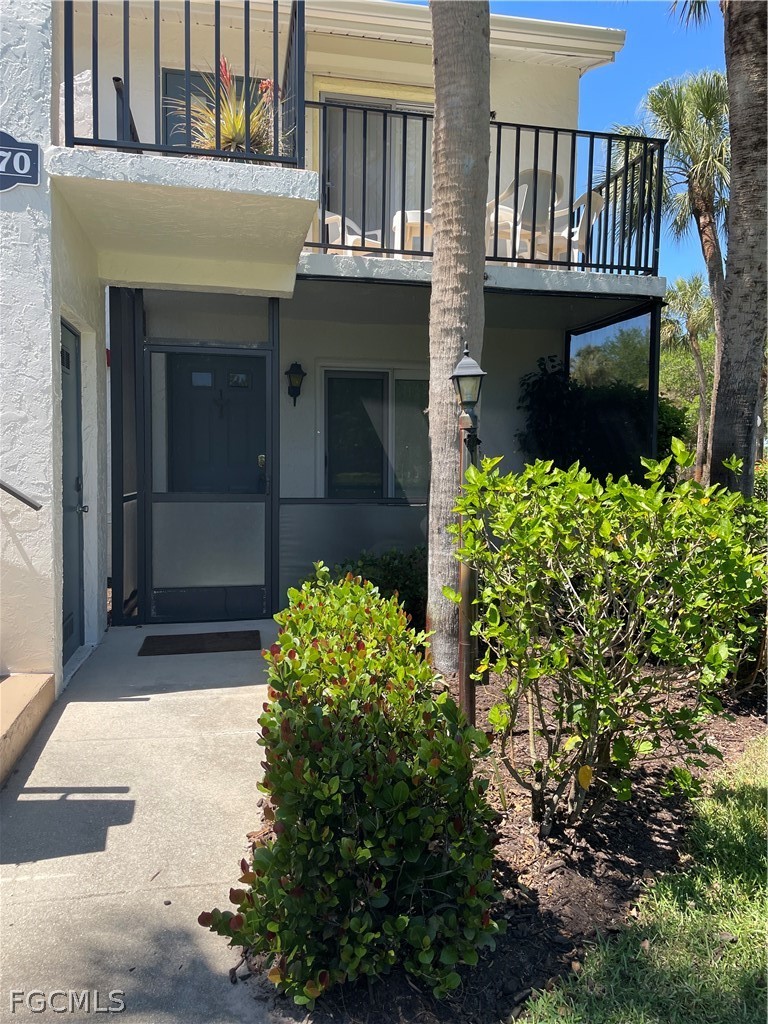 Entrance to property with stucco siding
