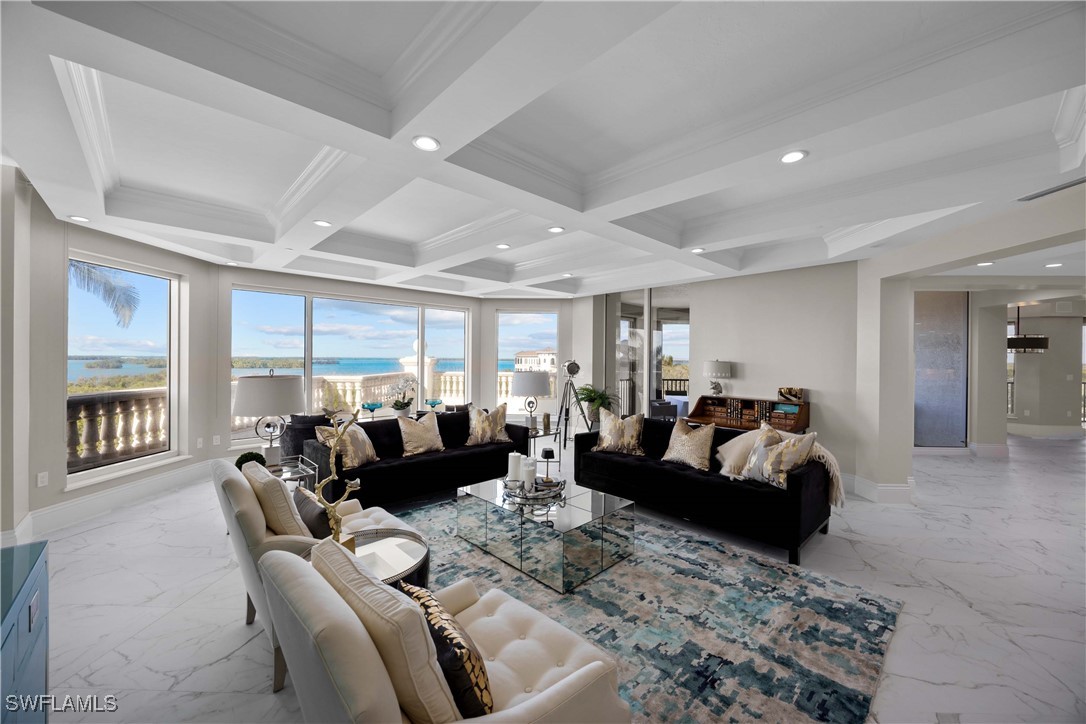 Living room with beamed ceiling, a healthy amount