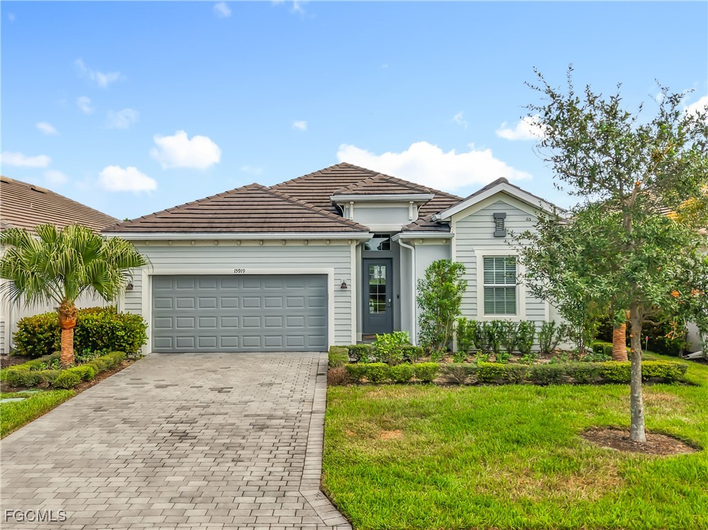 Ranch-style house with decorative driveway, an att