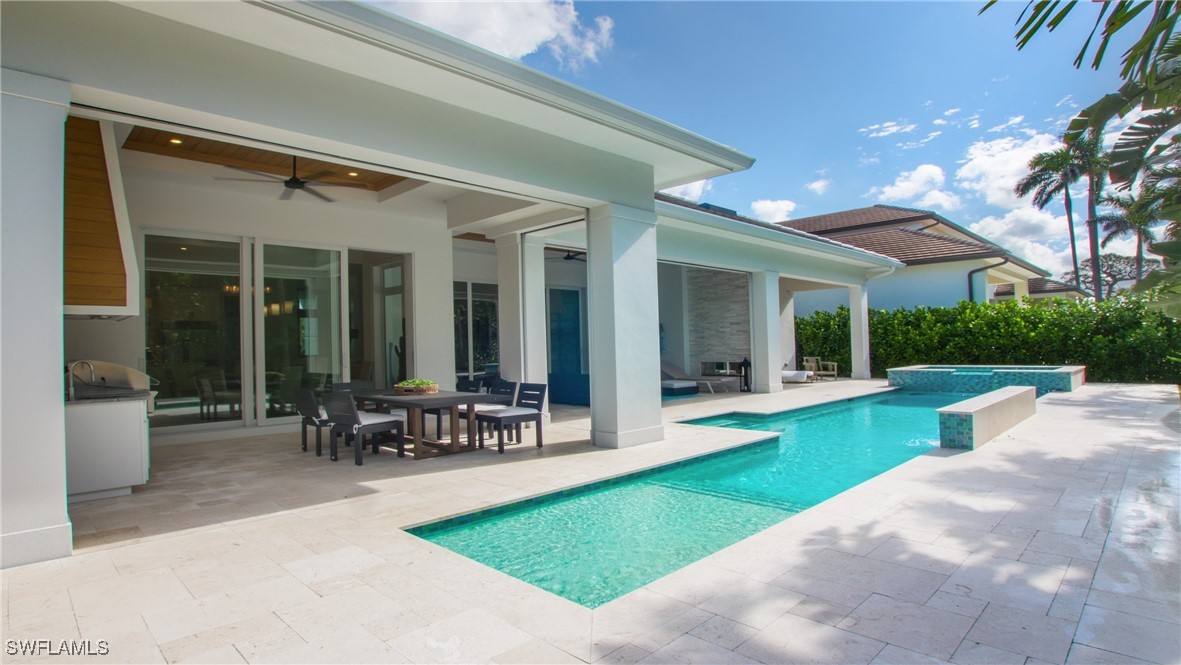 View of pool with a patio area and ceiling fan