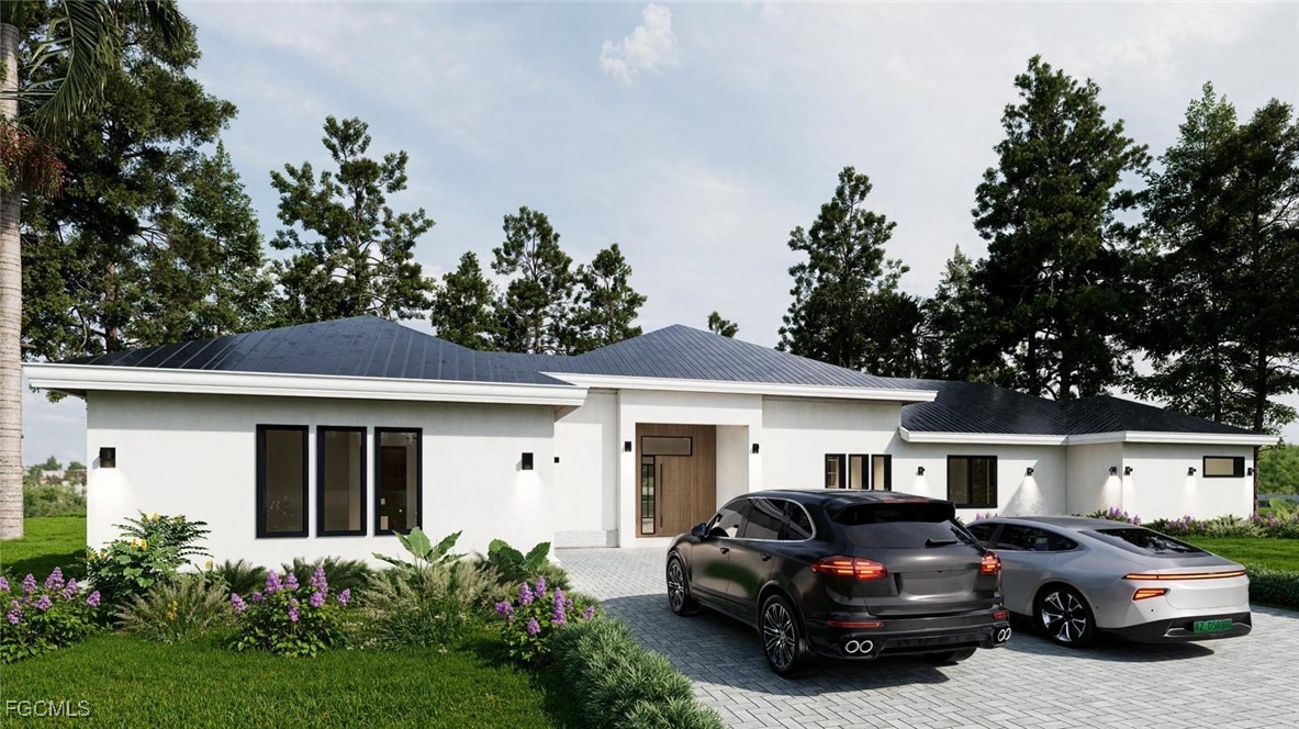 View of front of home with stucco siding, driveway