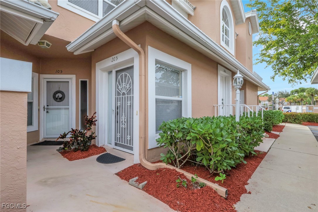 Doorway to property with stucco siding