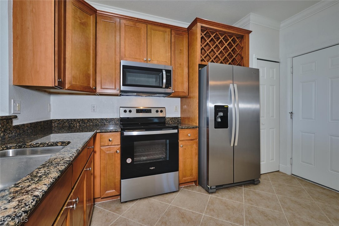 Kitchen with brown cabinets, stainless steel appli