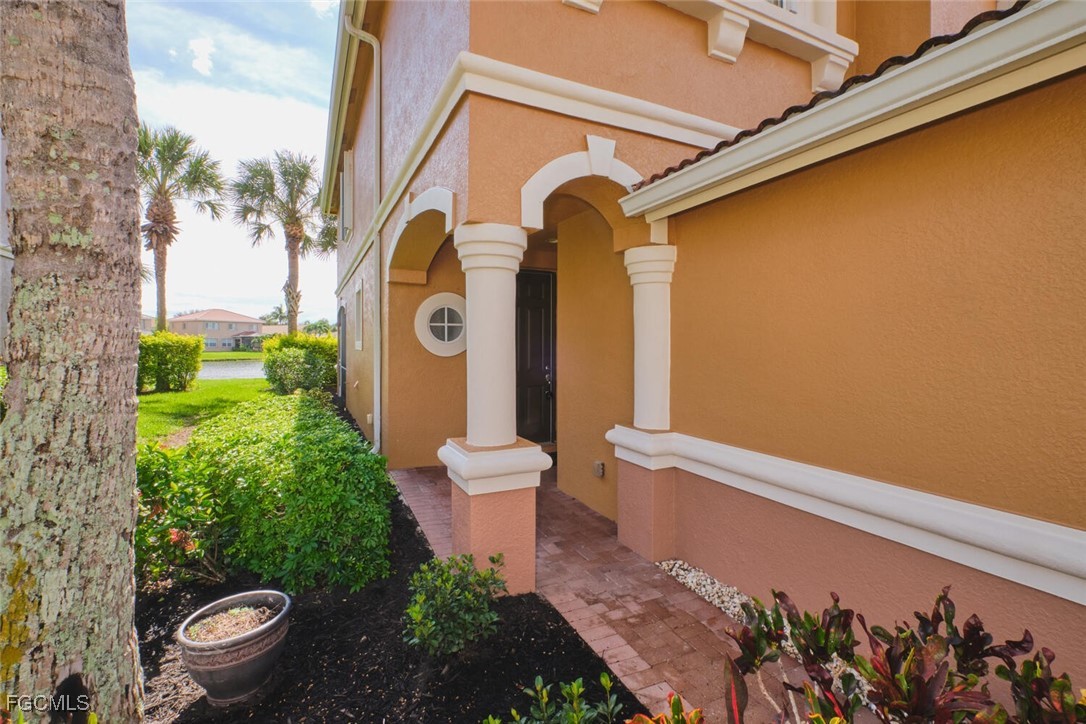 Doorway to property featuring stucco siding and co