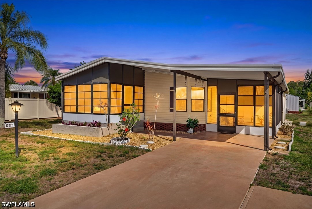 The open-concept living area features wood-look fl