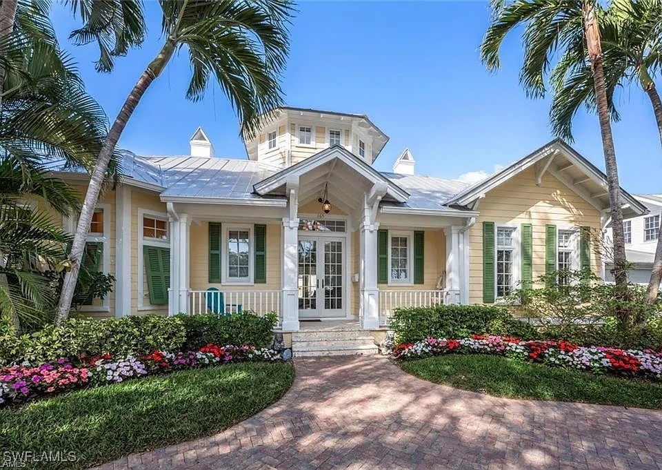 View of front of property featuring a chimney, fre