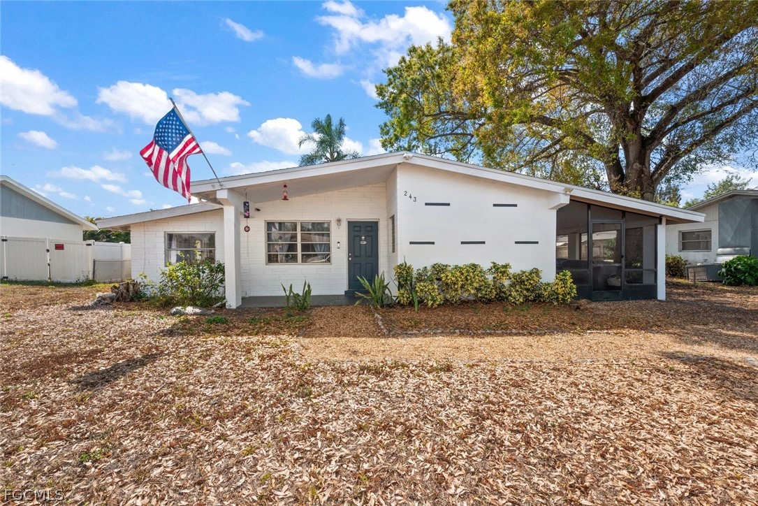 View of front of property featuring a sunroom and