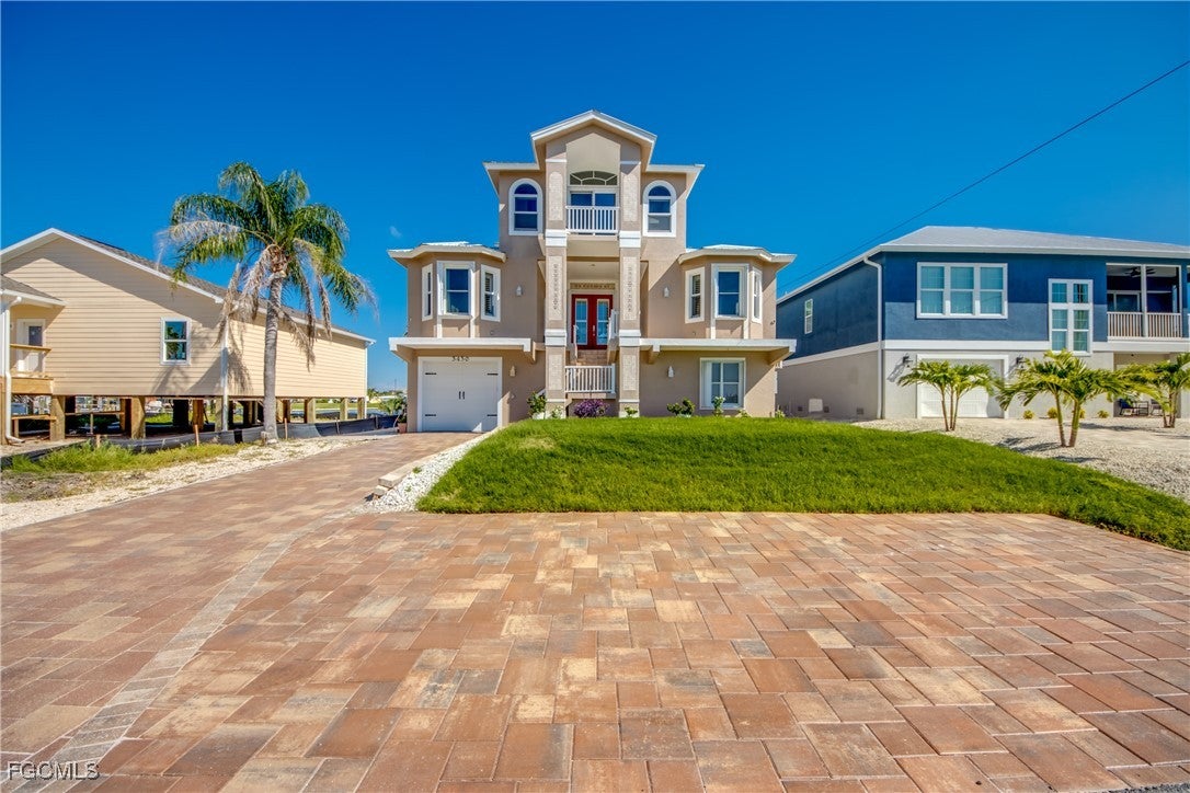View of front of property with stucco siding, a ba