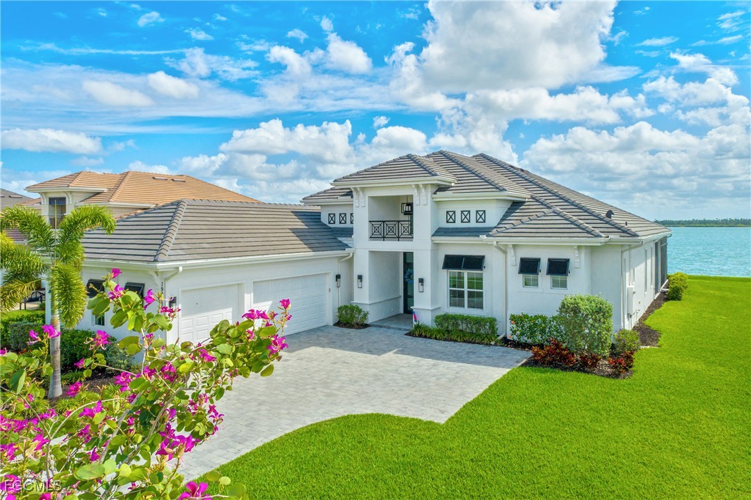 View of front of home with a garage, a front yard,