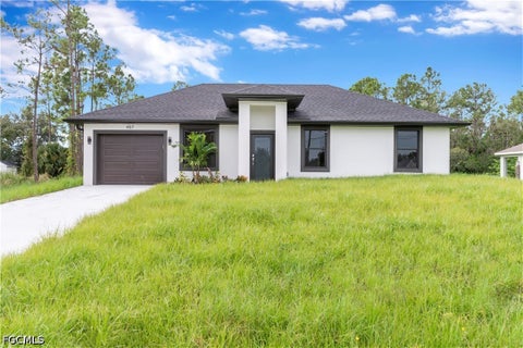 Photo of 457 Woodman Drive, Lehigh Acres, FL 33972 (MLS # 2026035588)