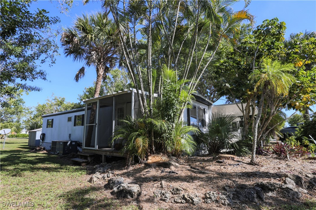 View of home's exterior featuring a sunroom and a