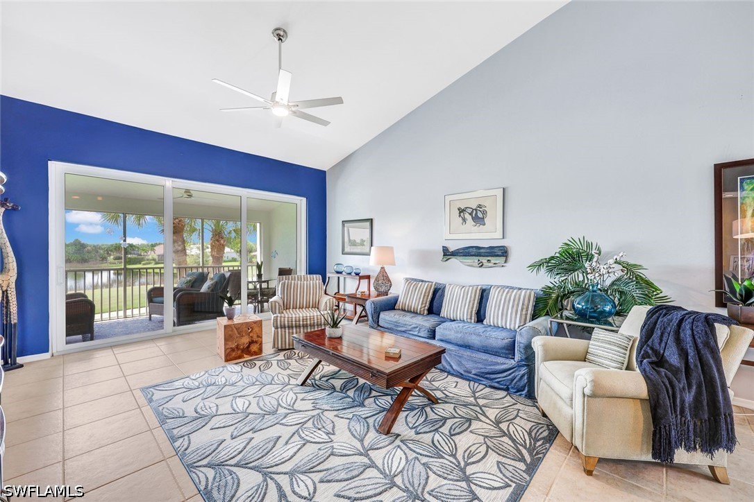 Living room with ceiling fan, light tile patterned