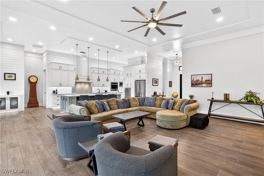 Living room with recessed lighting, a ceiling fan,