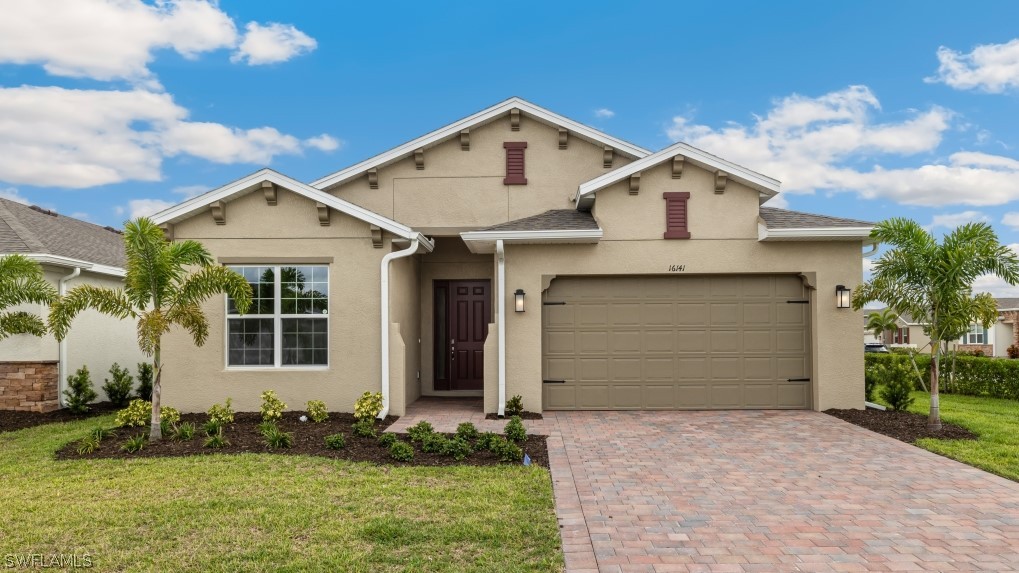 Model home. View of front of home featuring stucco