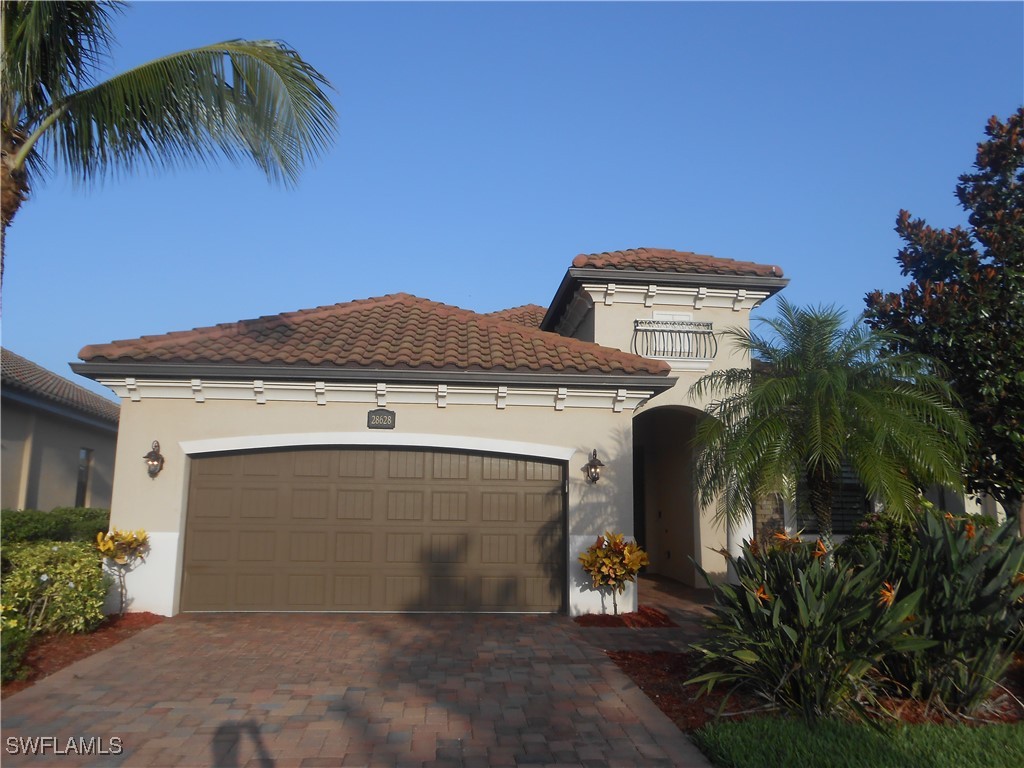 Mediterranean / spanish-style house featuring a ga