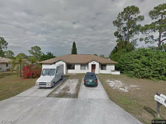 Single story home with concrete driveway