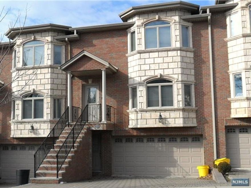 OVER SIZED TOWNHOUSE APPROXIMATELY 3000 SQUARE FEET. FEATURES AN AIRY FLOOR PLAN WITH 9 FT HIGH CEILINGS, BEAUTIFUL OAK FLOORING & MOLDING THROUGHOUT. OVER SIZED DINING ROOM WITH FIREPLACE, MODERN EAT IN KITCHEN WITH GRANITE COUNTER TOP & ISLAND. STAINLESS STEEL APPLIANCE PACKAGE, AND TUMBLED BACKS PLASH. SECOND FLOOR FEATURES A LARGE MASTER BEDROOM WITH FULL BATH, GLASS ENCLOSED SHOWER STALL, JACUZZI TUB, AND VANITY, TWO ADDITIONAL BEDROOMS, AND FULL BATH. GROUND LEVEL HAS TWO CAR GARAGE, FINISHED TILED LIVING ROOM, AND SEPARATE ENTRANCE. SOLID BRICK. PAVED DRIVEWAY. EASY ACCESS TO ALL HIGHWAYS. LAWN MAINT BY LANDLORD. SNOW REMOVAL BY TENANT.