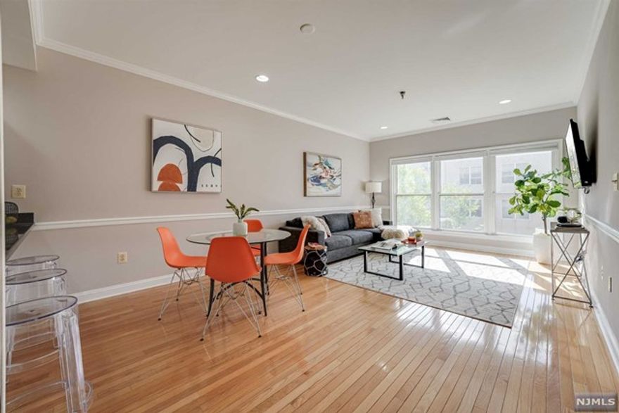 Looking for a spacious and bright condo in Hoboken? Look no further than this spacious 2 bed, 2 bath features an open layout with tons of natural light. This condo features an open floor plan with ample room for living and dining, along with a wrap around kitchen island with seating, granite countertops and upgraded appliances. The expansive and light filled primary bedroom has a walk-in closet and attached bathroom with shower-bath and double vanity. The second bedroom is also light-filled, with a closet and a generously sized hallway bathroom with shower-bath. With newer windows, washer/dryer in-unit and hardwood floors, this condo is move-in ready. 84 Adams is an amenity filled building with a fitness center, 1 deeded and covered parking space, storage unit, common rooftop and landscaped yard. Fabulously located in Downtown Hoboken, close to the PATH for an easy commute, restaurants, shopping. Convenience is key!