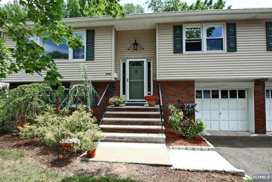 Wonderful opportunity! located in the Radburn school area, situated on a quiet tree-lined street, this beautiful home offers over 2,000 sf of open layout. Updated Eat-In kitchen with stainless steel appliances, ceramic tile floor and granite counter top, as well as a large window and a French door to a beautiful deck looking over a fenced-in private back yard with a shed. First floor also has large living room, formal dining room, Primary bedroom + updated bath, 2 generous size bedrooms and an updated full bath, all with hardwood floors. Lower level offer another bedroom, family room with sliding glass doors to the back yard and patio, guest bathrooms and lots of storage. This home is located minutes from houses of worship, express bus to New York, shopping and beautiful parks. DO NOT MISS THIS OPPORTUNITY!
