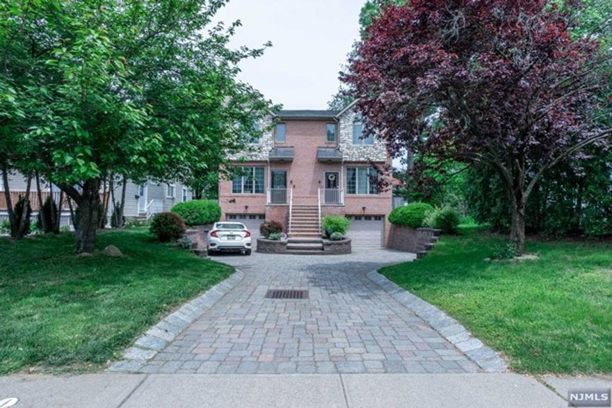 Immaculate and move-in ready! Bright and sunshine filled South facing young duplex. Open floor plan, high ceilings, & tremendous amount of natural light. Quiet residential street with convenient location to heart of Tenafly. The first floor flows from the entry foyer entrance to the Modern custom kitchen with granite countertops, large living room and family room. The second floor has three bedrooms and two full bathrooms. Primary Bedroom has high coffered ceiling ensuite bathroom with jacuzzi tub. All hardwood floors throughout and large finished lower with beautiful porcelain tiled floor, recreation room is ideal for an office or gym/flex space, full bathroom, and laundry. Wonderful outdoor space with patio deck (10x14) for outdoor enjoyment of the backyard. Walking distance to Top Tenafly public schools and easy, quick commute to NYC. Convenient to lovely downtown Tenafly and all of the area amenities.