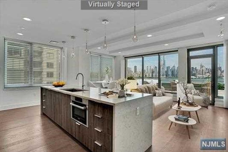 Discover the most premier and luxurious new construction building along the NJ Gold Coast. This beautiful 3 bedroom, 2 full baths, modern designed home has all the finest finishes & the most breathtaking DIRECT EAST views of NYC & Hudson River. YOU WILL NEVER GET A TERRACE THIS LARGE ON THE ENTIRE WATERFRONT W/A GAS LINE FOR GRILLING & ENOUGH SPACE FOR THE WHOLE FAMILY-Grill included! Enjoy the world-class design and perfect floor plan stretching across 1510 sqft. Professional chef's kitchen featuring a large center island w/Aspen quartz countertops, Pedini cabinets, Bosch appliances, & Thermador fridge. Enjoy the wood flooring throughout, in-unit W/D, expansive closet space, ceiling fans in every room, towel warmers, 1(Opt2) garage car parking, & oversized windows w/custom automated shades & blackouts. The resort style amenities: 24-hr doorman, state-of-the-art 2 level fitness center, amenity deck w/infinity pool & BBQ area, rooftop deck w/cabanas, shuttle to/from Ferry!