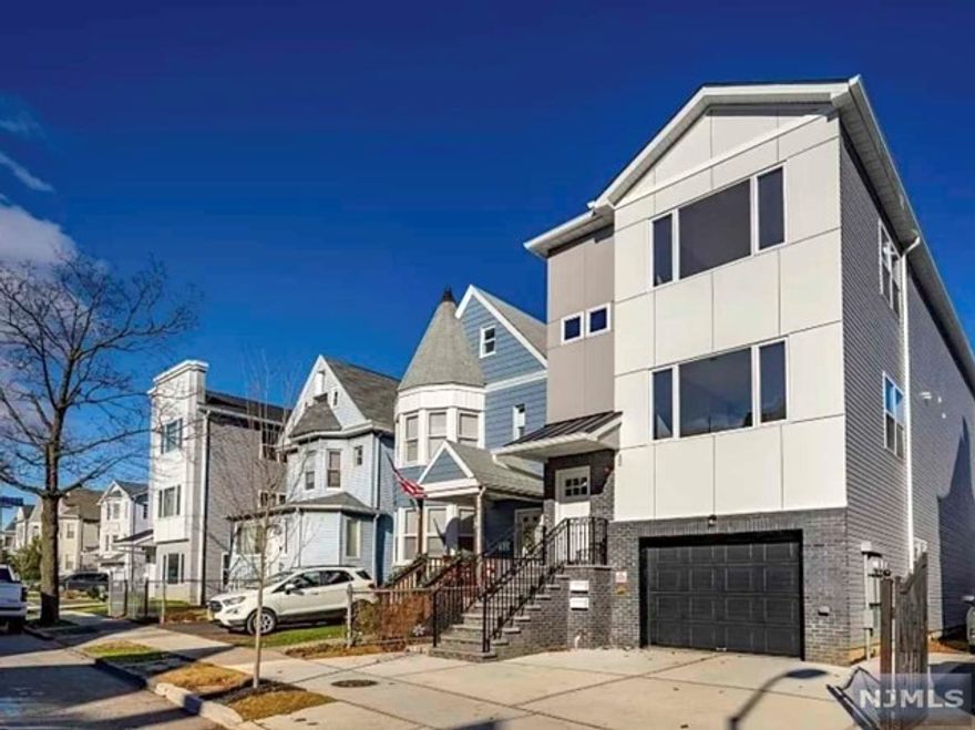 Stunning brand-new construction home at 32 William St in East Orange, NJ, offers three bedrooms, two baths, and a seamless blend of modern comfort and luxury. Step inside to discover an inviting interior flooded with natural light, sleek finishes, and high-end fixtures throughout. The open-concept layout connects living, dining, and kitchen areas, perfect for entertaining. The gourmet kitchen features premium appliances, quartz countertops, ample cabinetry. Retreat to the serene primary bedroom suite with a walk-in closet and a luxurious en suite bathroom. Additional highlights include hardwood floors, central heating and cooling, and a convenient laundry room. Conveniently located near local amenities and transportation options, this home epitomizes luxury living in East Orange.