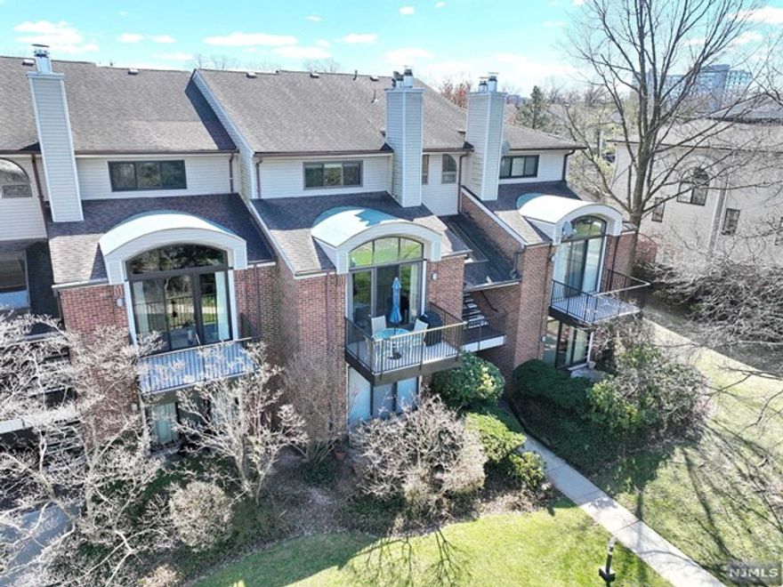 Experience luxurious living in this elegant 3-bedroom, 2.5-bath townhome in the "The Courts of Glenpointe" Boasting 24-hour gated security. Step into a sunken living room w/ wood-burning fireplace, vaulted ceilings, & a charming balcony, for BBQs or al fresco dining. The modern kitchen features granite countertops and stainless steel appliances, flowing into a cozy family room. Hardwood floors & recessed lighting add warmth throughout. Upstairs, a primary bedroom ensuite, with jacuzzi tub, separate shower, & walk-in closet. 2 additional bedrooms, a full bath, & a convenient laundry room round out the upper level. Elevate your living experience with private elevator access to the 2-car tandem garage & a storage unit. Enjoy exclusive residency perks, including access to a pool, clubhouse, tennis court, & fenced dog run. Commuting is a breeze with an express bus to NYC & major highways nearby. Enjoy urban amenities with Park & Stables nearby.