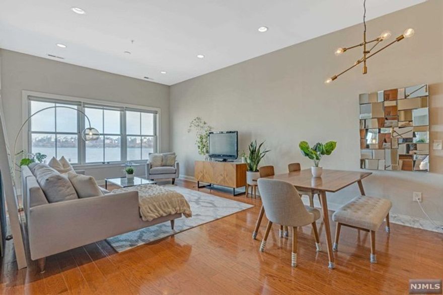 Lavish, visually stunning TOP FLOOR corner unit, NE & West facing, 2BR/2BA home with stunning views of NYC/Hudson River, located in Grandview II. Spanning 1,386sf, this home features h/w floors throughout, NYC/Hudson River views from every room, maximal 10-ft ceilings, in-unit full-size W/D, 1-car garage parking & more! The open floor layout creates an easy flow from the kitchen featuring Viking & Sub-zero appliances, granite countertops, & a center island to the living & dining room, then to the private balcony. Down the hall is the primary ensuite, custom WIC & modern spa-like bath with dual vanities, a separate shower, & Jacuzzi. The generous size 2nd BR has thrilling views of NYC/Hudson River & another full BA across the hall! Grandview II amenities are currently being upgraded & include a 24hr concierge, fitness center, children's play area, outdoor swimming pool, resident lounge, shuttle to/from Ferry/Light Rail, restaurants, shops, grocery store, & Starbucks all close by.