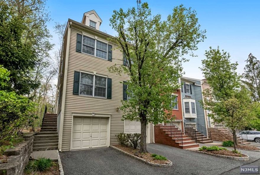 Turnkey! Desirable & updated end unit in the Williamsburg section of Cambridge Heights. Light and airy, this modern space features fresh neutral hues and an open floor plan. The white eat-in kitchen has newer appliances & easy access to a balcony overlooking private woods. The main living space features a wood-burning fireplace and hardwood floors. There are two generous bedrooms on this floor including a primary suite with its own bath, walk-in closet, hall bath & laundry. Downstairs, find an amazing walk-out recreation room or guest space with half bath & attached garage with charging station. Gated community. Convenient location to schools, shops major highways & NYC train. This won't last.