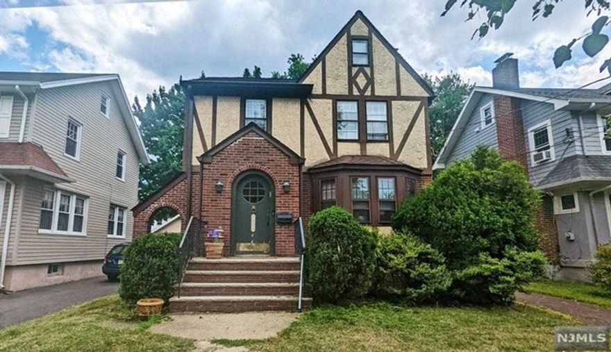 Spacious colonial tudor in Teaneck. First floor has living room, dining room, modern kitchen, den, screened in porchand powder room. Second floor primary bedroom, two additional bedrooms and a full bathroom. Walk up storage attic. Unfinished basement with laundry. Detached two car garage.