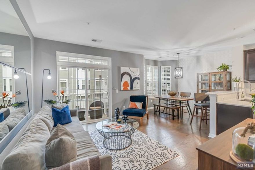 In the heart of Garfield, this charming 2bd 2.5ba home offers a perfect blend of comfort and convenience. Open-concept layout welcomes you with natural light, spacious living areas and modern finishes throughout. Fully equipped kitchen boasts quartz countertops, SS appliances & a breakfast bar. Once in living room, there is access to outside through terrace where you can unwind and enjoy outdoors. The main bedroom includes an ensuite bath with jetted tub, standup shower, double vanity & a walk-in-closet for all storage needs. The den makes perfect for an add'l family room area or potential 3rd bedroom. Central A/C & heat, hardwood floors, laundry room & parking complete this home. With its prime location near transportation & all major highways (Rt. 80, GSP, Rt. 21, Rt. 46) this townhome presents an opportunity for an serene lifestyle in a desirable community. Amenities include pool, exercise room, community room & EV charging stations on site! Make this your home today!