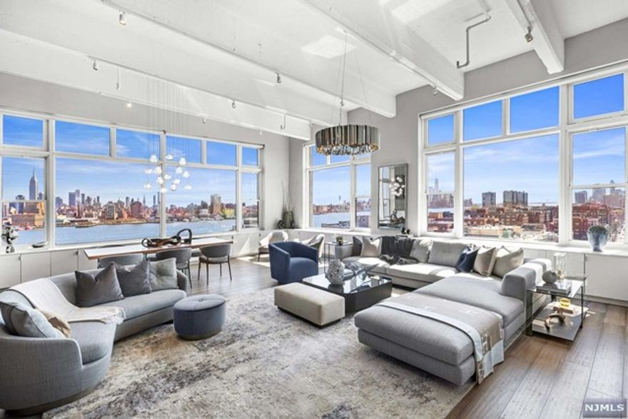 This stunning penthouse corner loft at the Hudson Tea Building is unquestionably one of the premiere apartments in all of Hoboken and the NJ Gold Coast. One of the only true loft buildings situated directly on the Hudson River and located in Hoboken's most sought after uptown neighborhood 12IJ offers awe-inspiring, commanding and direct unobstructed panoramic views of New York City and the Hudson River from nearly every room. These truly one-of-a-kind views stretch from the George Washington Bridge to the Verrazano Bridge and encompass many of New York City's most iconic buildings including the Empire State building and the Freedom Tower. Located on the top floor of a former tea factory, 12IJ is a combination of two apartments that has produced a stunning, design-inspired 2,820 square foot three bedroom, three bathroom loft apartment with 14' ceilings and oversized 10' windows in nearly every room. Emanating modern sophistication and elegance at every turn...